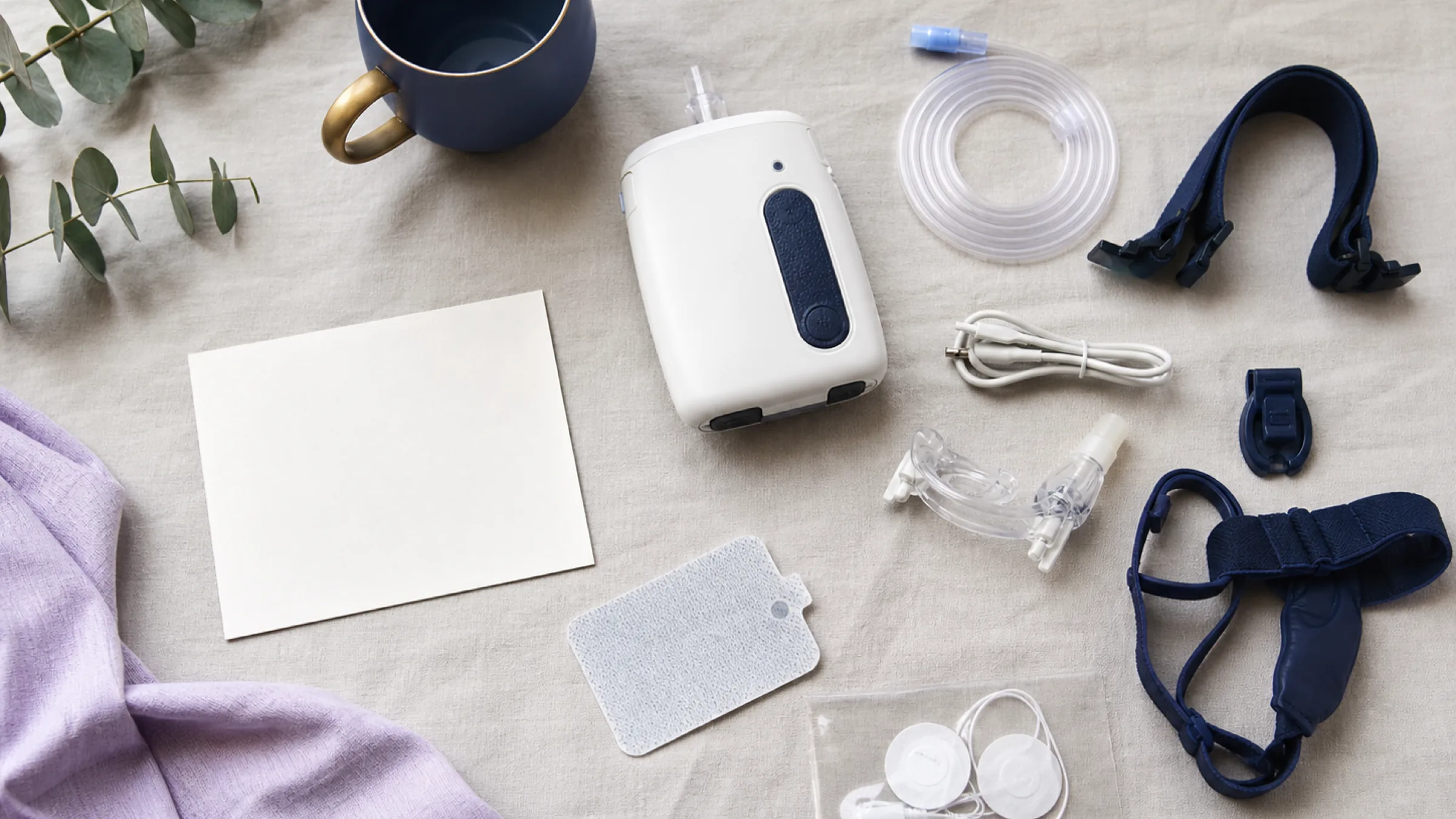 CPAP machine, tubing, mask cushion and headgear laid out for replacement
